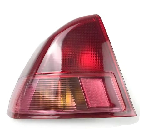 A close up view of a halogen tail light with a bulb inside the housing 