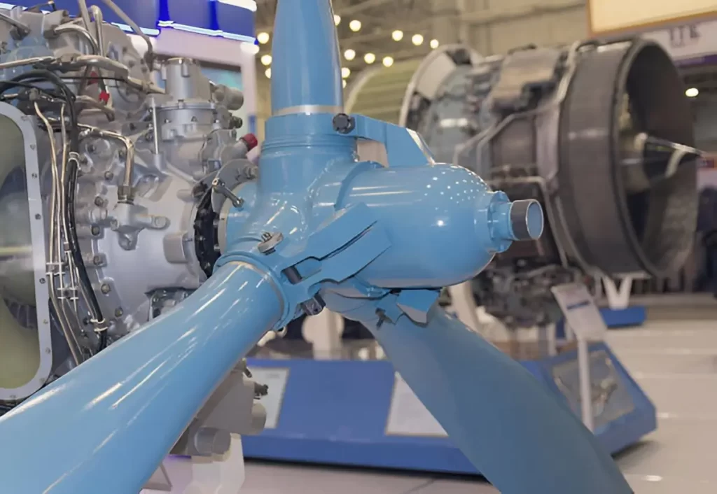 Polished blue screw parts alongside an aircraft engine.