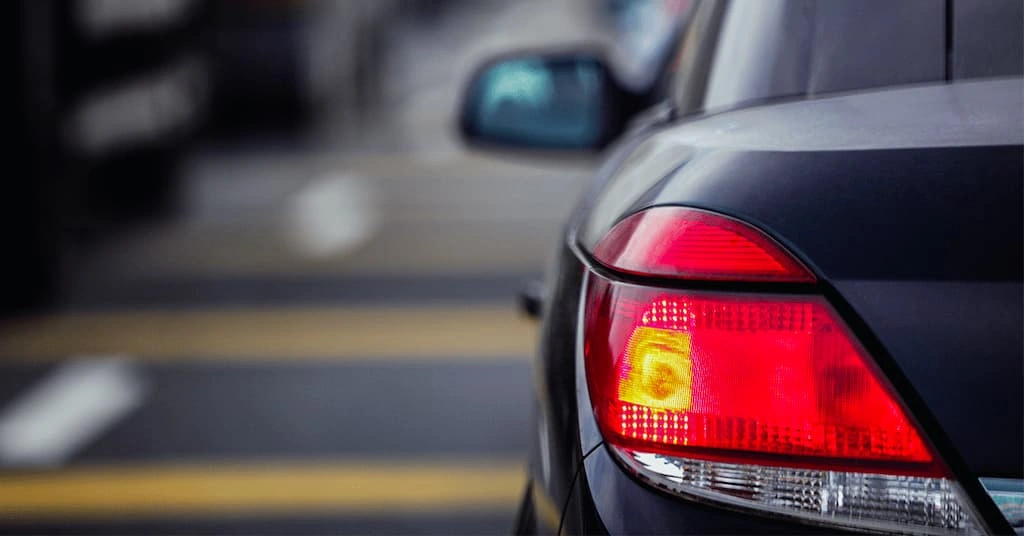 An image of a car’s taillight glowing red 