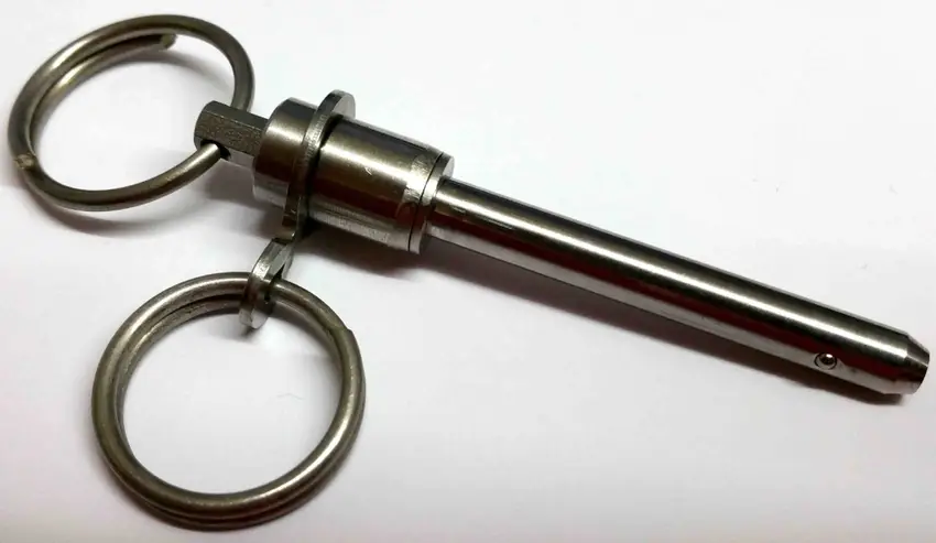 A closeup of a silver colored aircraft lock pin