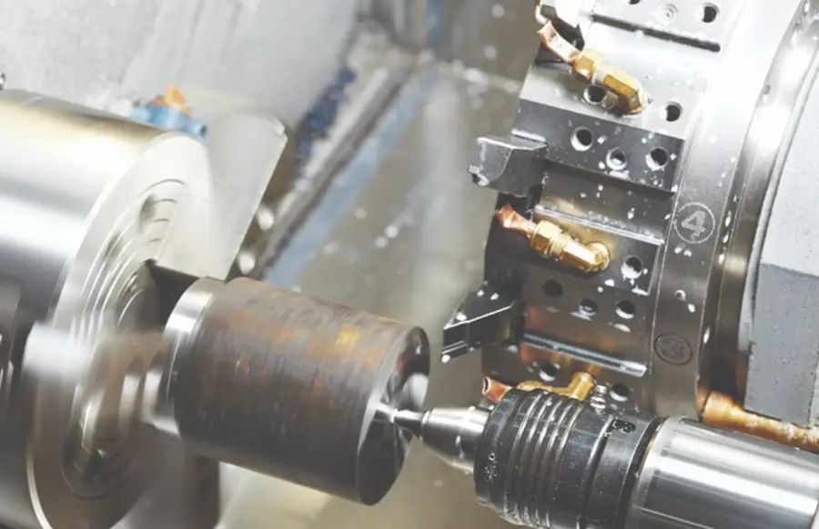 Workpiece being machined on a conventional lathe with a cutting tool engaged 