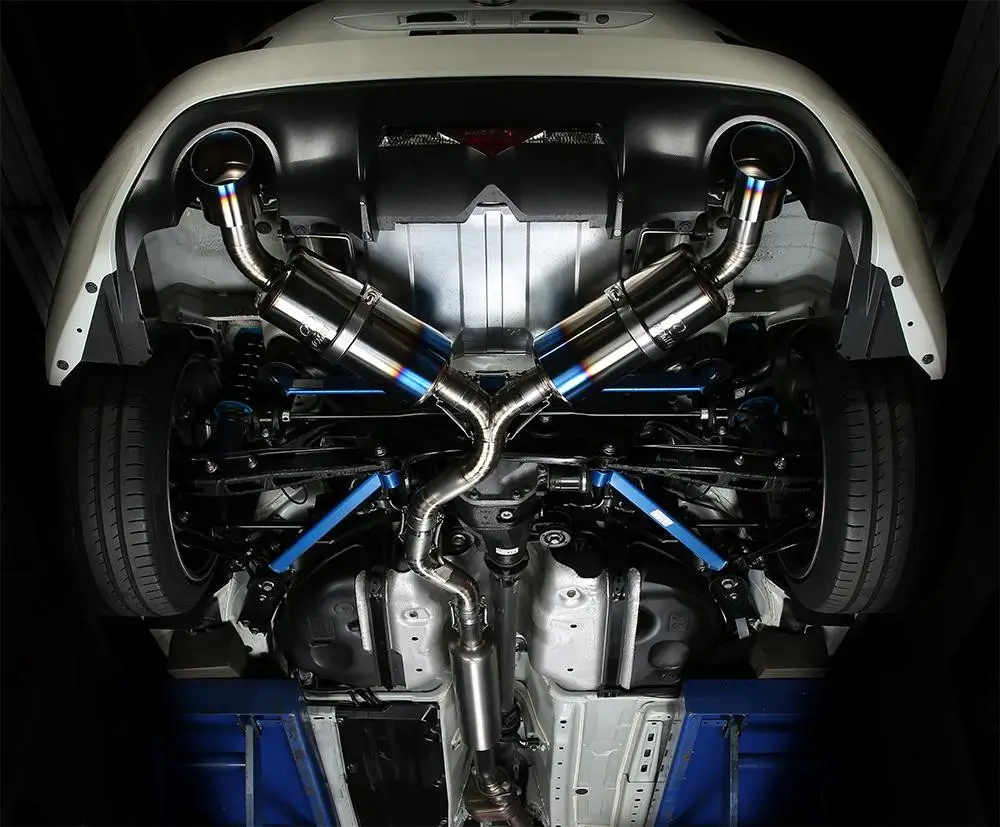 CNC-machined Inconel exhaust system installed under a sports car.