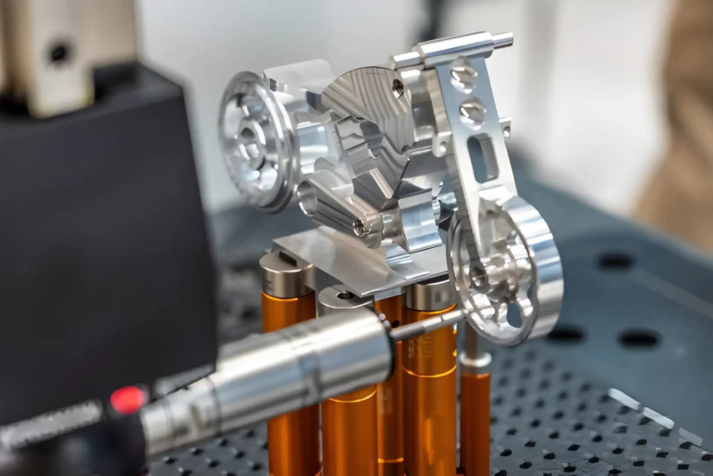 Quality control technician measuring a machined part with 3D measurement equipment.