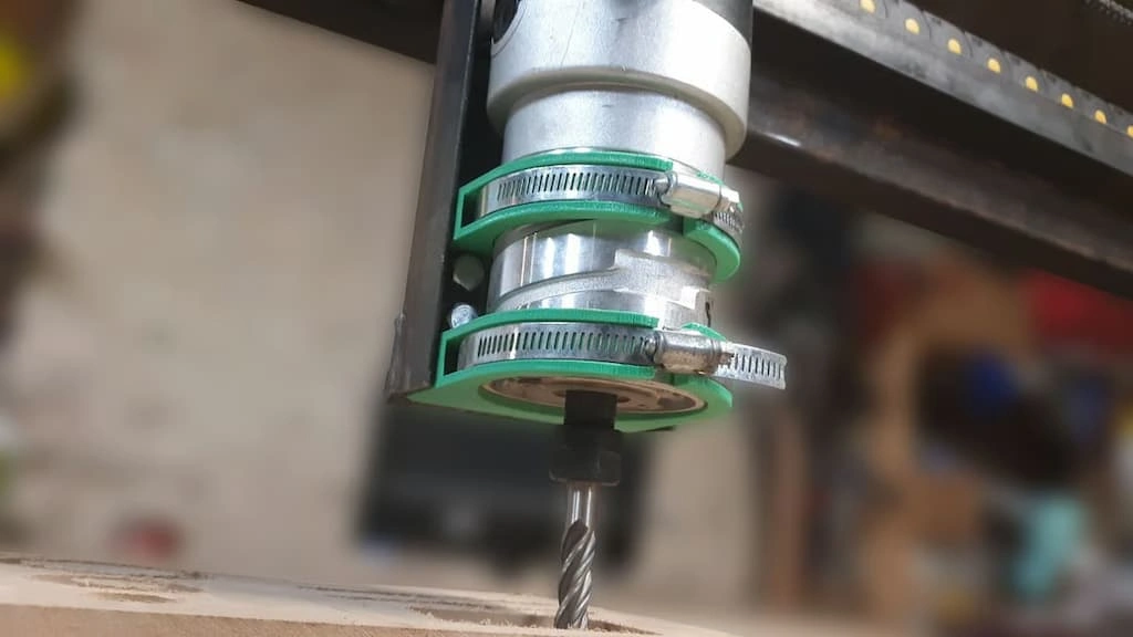 A close-up view of the CNC router spindle with a cutting tool attached to it. 