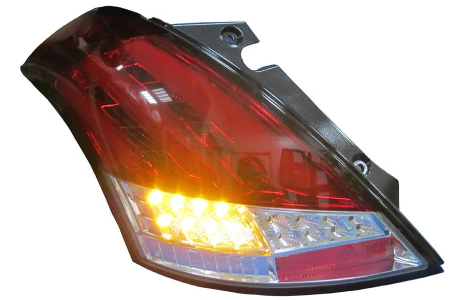 Illuminated car tail light with red and amber LED sections in a clear polycarbonate housing