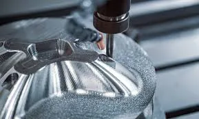 Close-up of a CNC milling machine cutting a precision metal component with a smooth reflective finish.