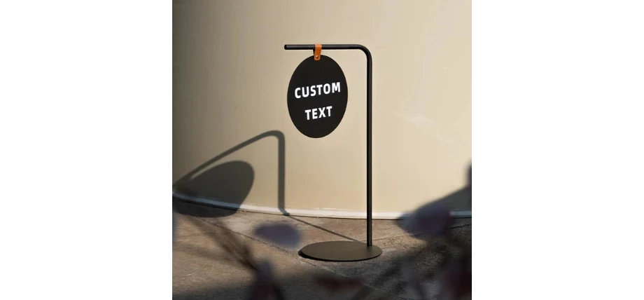 A black circular sign displaying