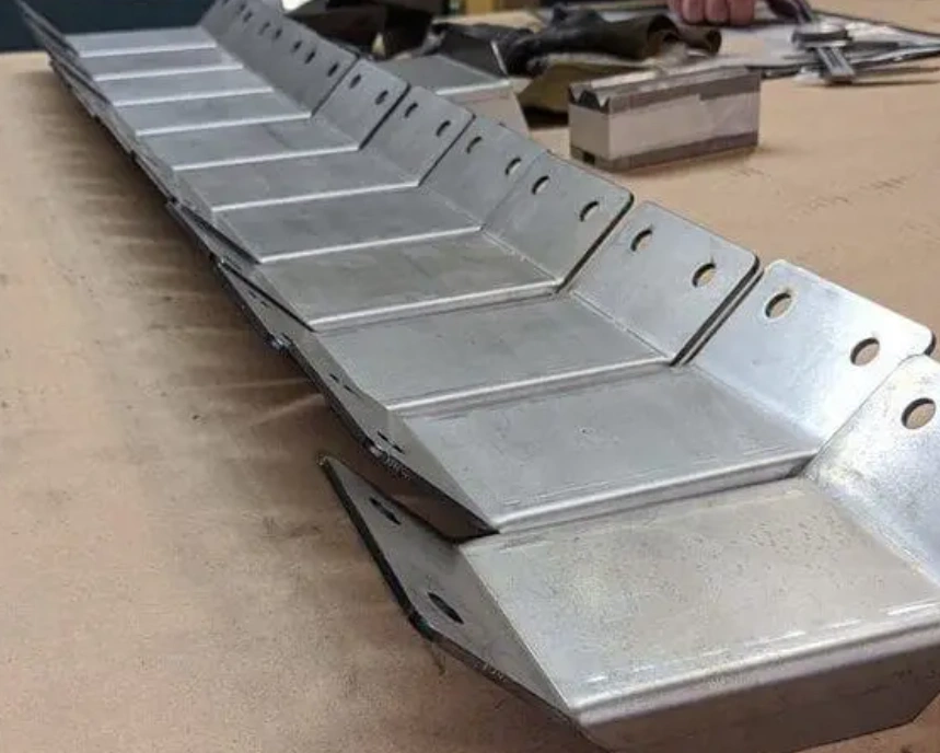 Bent sheet metal components with precision folds on a workshop table