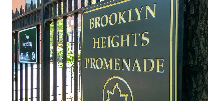 Gold-lettered dark metal sign for