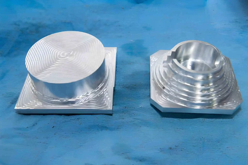 Steel threaded part shown after CNC machining. It displays a transition from a solid metal block to the finished component.
