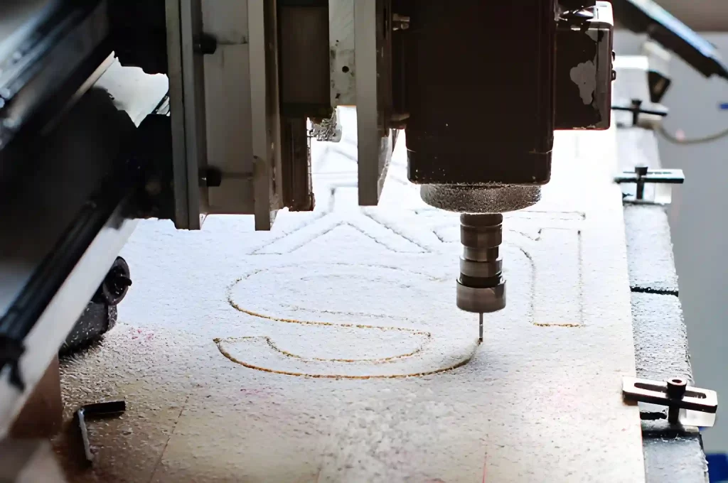 Text being engraved on a wooden sheet using a laser engraving machine.