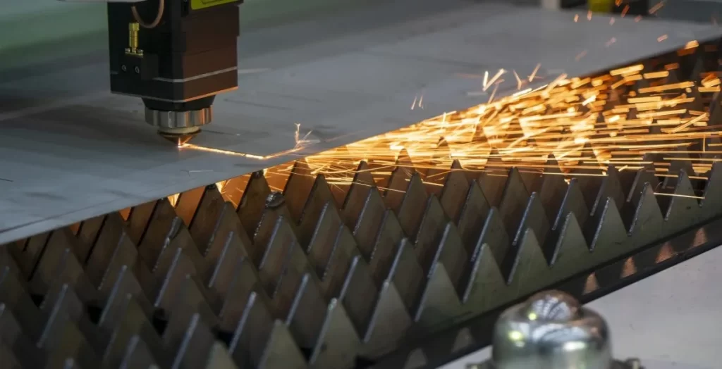Laser cutting steel sheet with sparks on a support grating