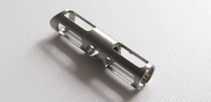 A small part made up of titanium created by a turning process