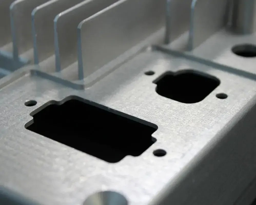 Close-up of custom 7075 aluminum machined part showing precision milling and surface texture detail