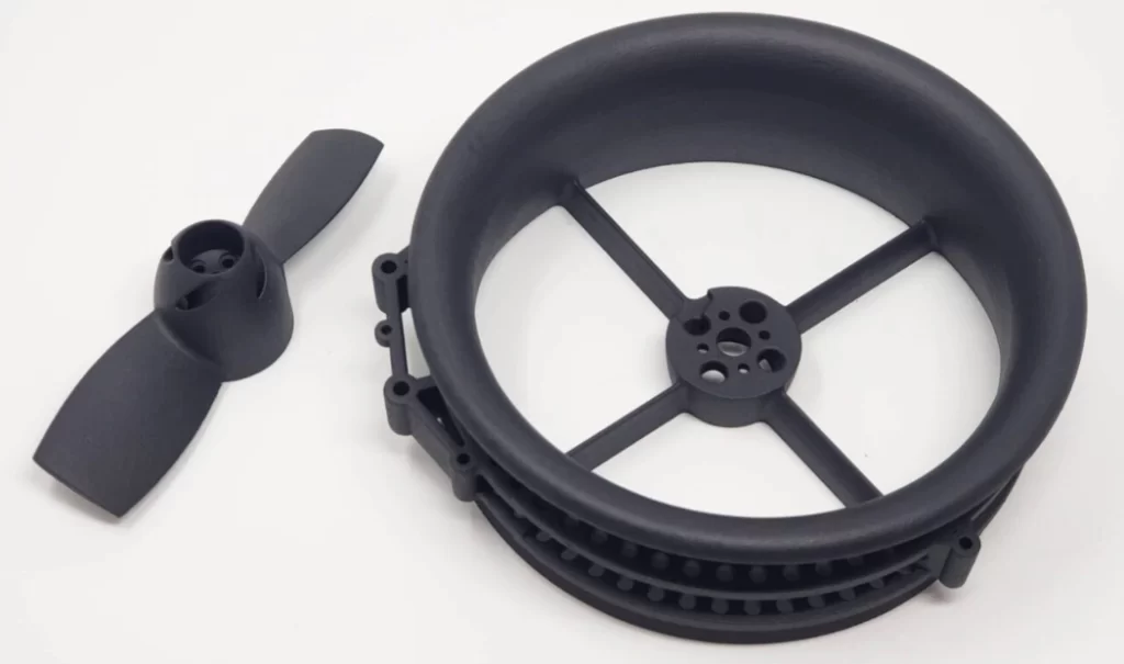 A black nylon propeller and a pulley wheel