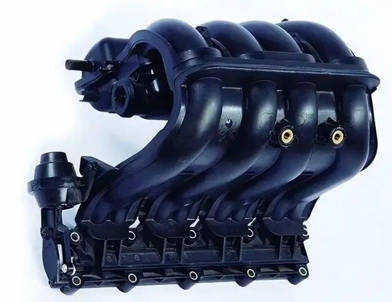 A black nylon intake manifold assembly showing complex automotive component design
