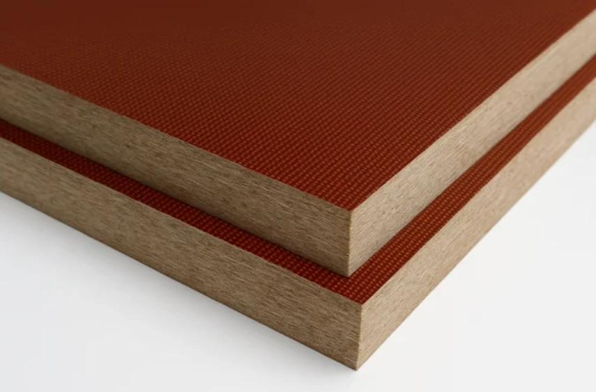 Layered phenolic laminate sheets showing fabric texture and edge cross-section