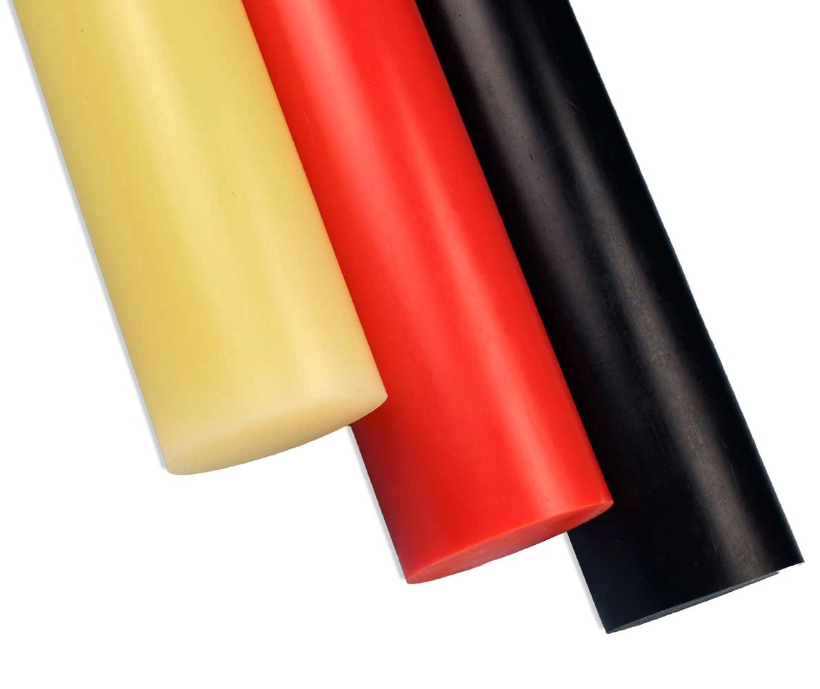 Polypropylene rod stock in natural, red, and black colors, showing raw material for CNC machining