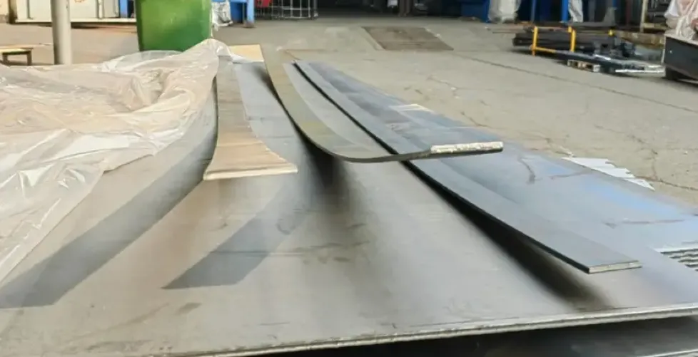 Slit, warped steel plates on a floor