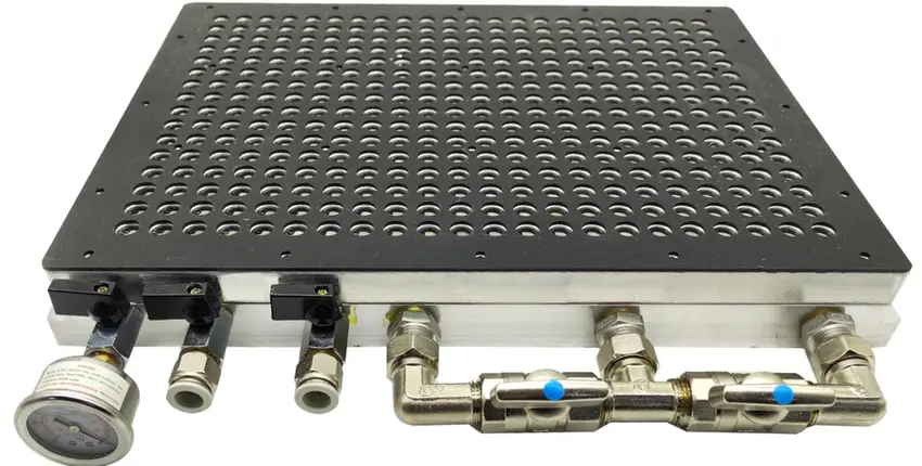 CNC vacuum chuck fixture with perforated ceramic plate and pneumatic fittings for workpiece clamping during machining
