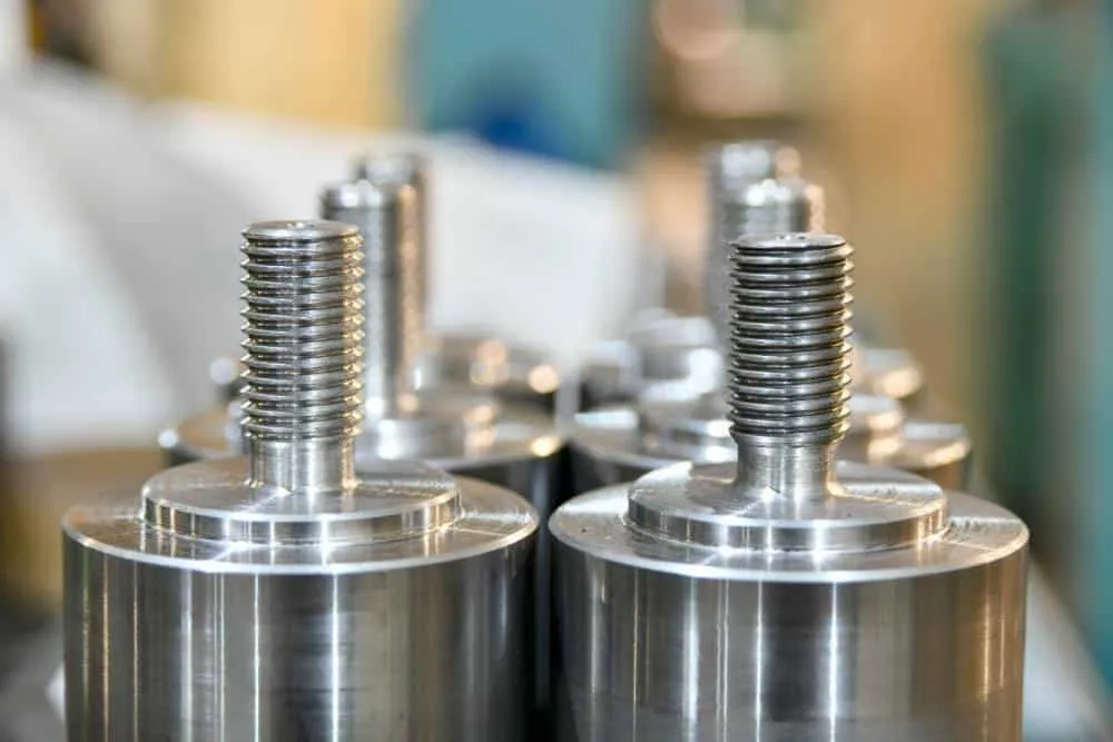Close-up view of piston-shaped shiny stainless steel parts