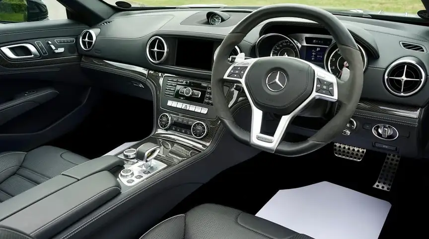 Luxury car interior featuring ABS plastic dashboard trim, center console, and air vent components with chrome accents