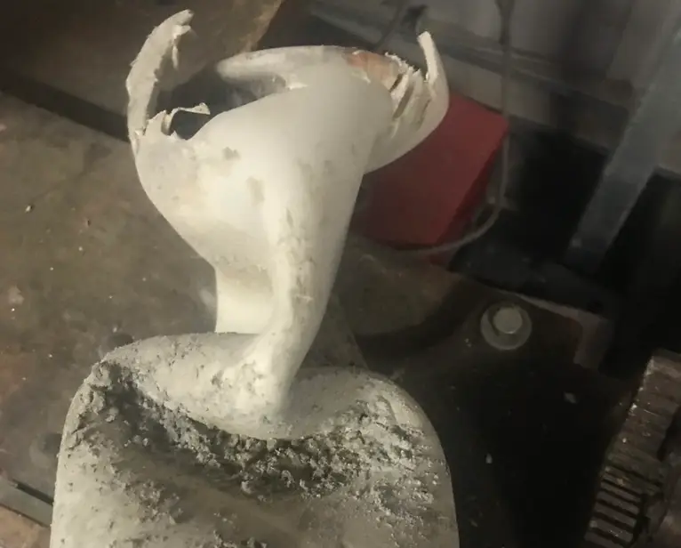 Softened and deformed PVC thermoplastic pipe after exposure to hot water, showing heat-reversible malleability