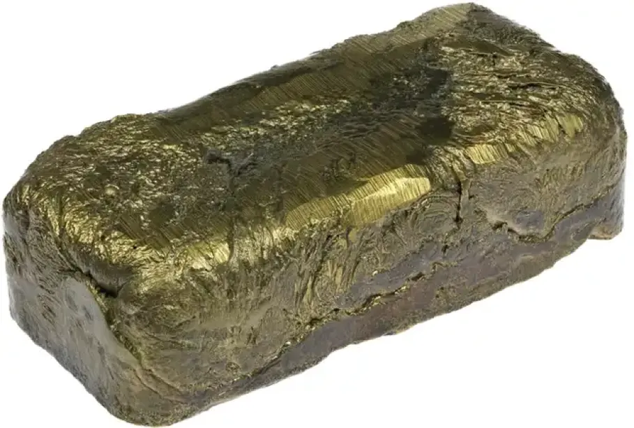 Raw brass ingot with rough textured surface showing metallic gold and gray coloration