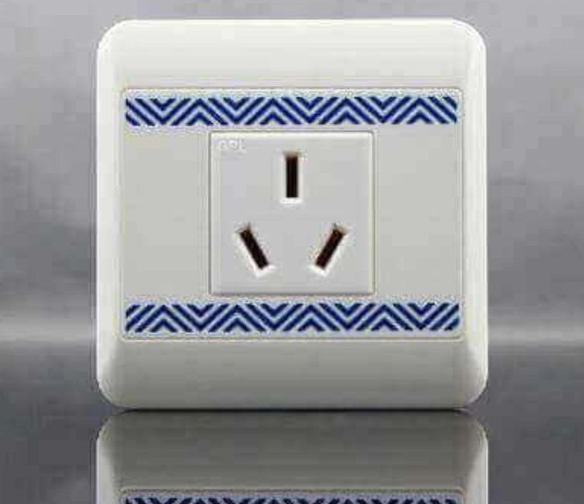 White ABS plastic electrical outlet cover with decorative blue chevron pattern trim
