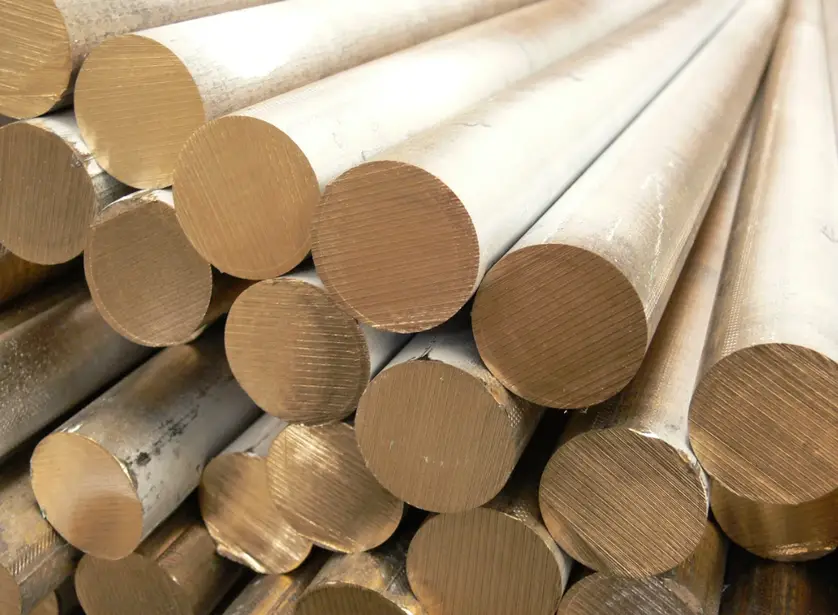 Naval brass cylindrical shafts showing machined circular end faces with visible grain patterns