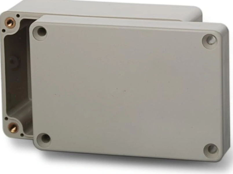 Grey ABS plastic industrial equipment enclosure with lid and metal threaded inserts.