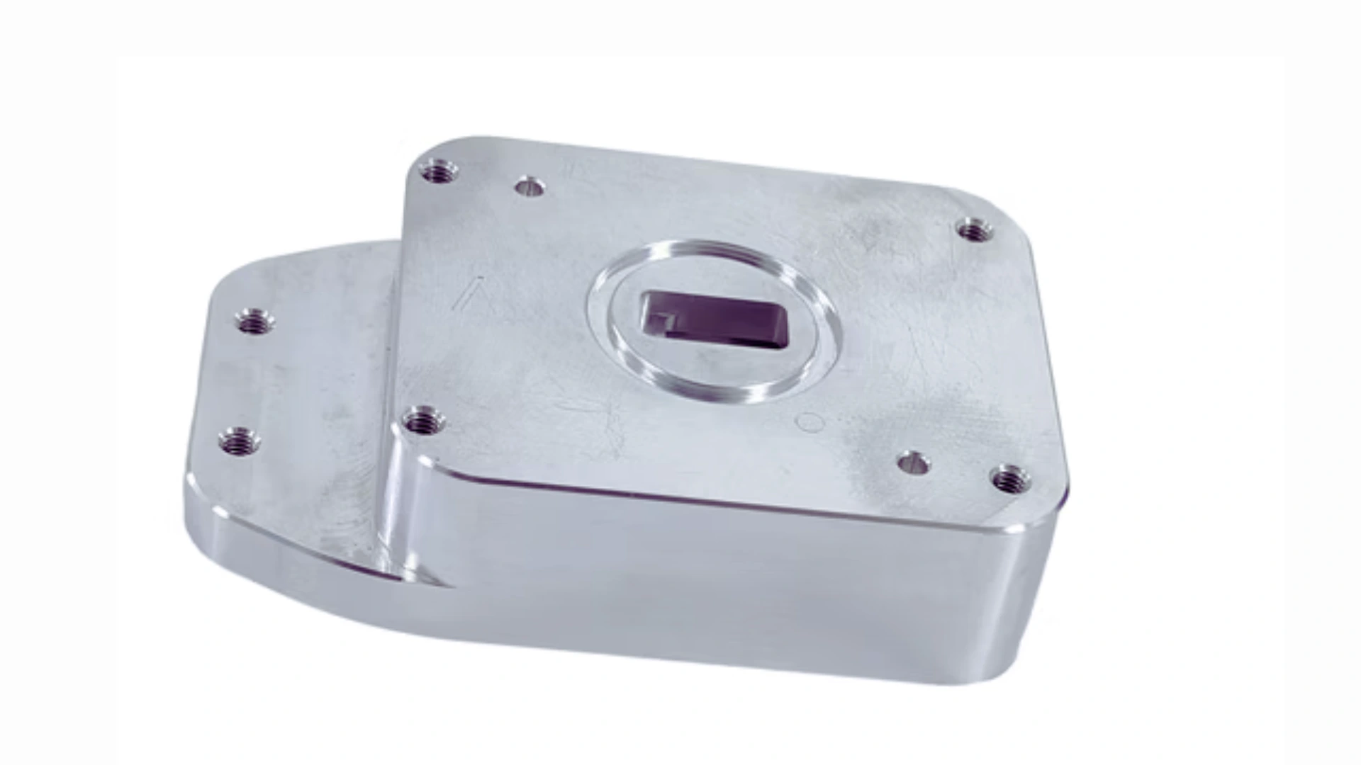 A machined aluminium block with a rectangular pocket and a row of tapped holes
