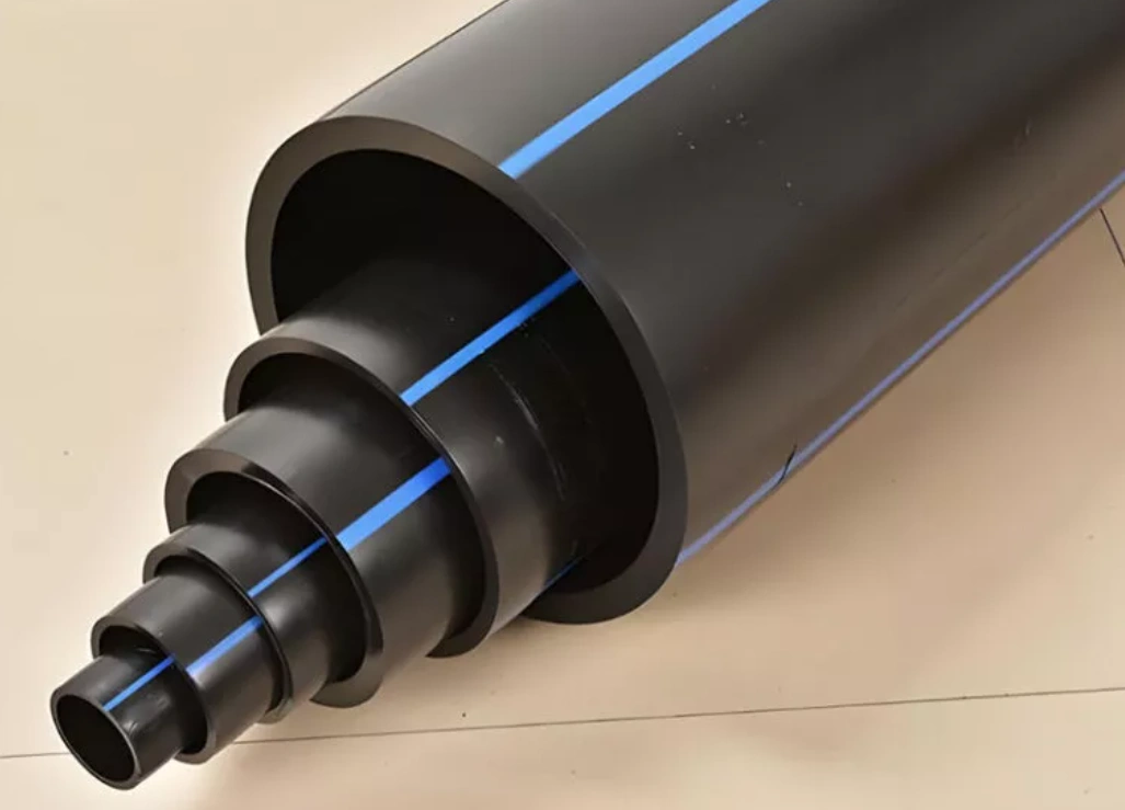 Black HDPE pipes with blue identification stripes in graduated sizes from small to large diameter