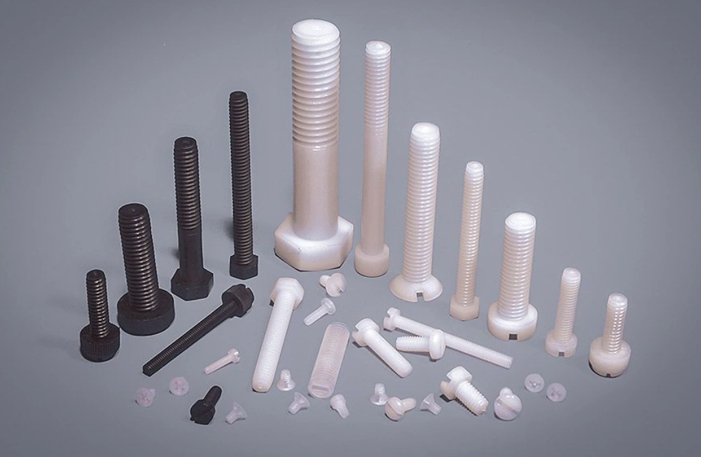 Assorted white and black nylon screws, bolts, and fasteners in various sizes