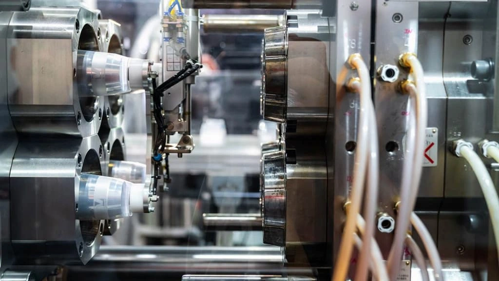 A close-up view of a plastic injection molding machine