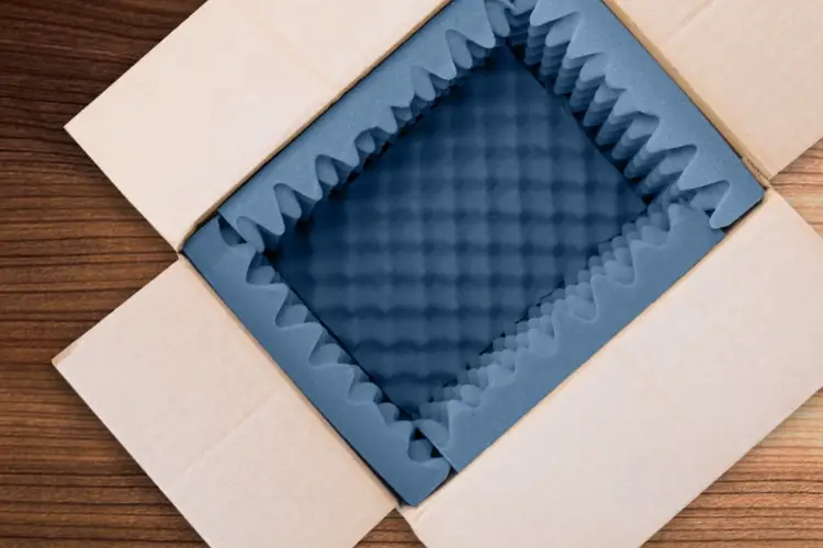 Blue convoluted packaging foam insert in a cardboard box showing cushioning application