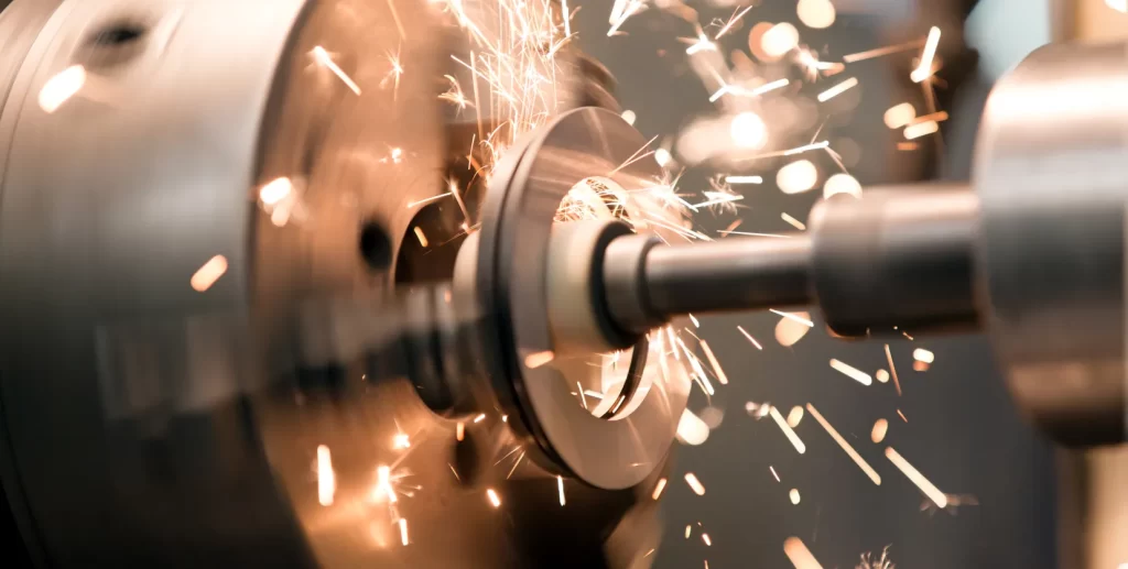 Metal lathe cutting tool creating sparks while machining a steel part