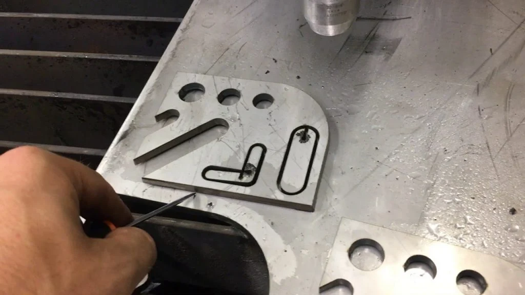 The image shows a high-quality plasma cut on an aluminum sheet with smooth, and precise edges