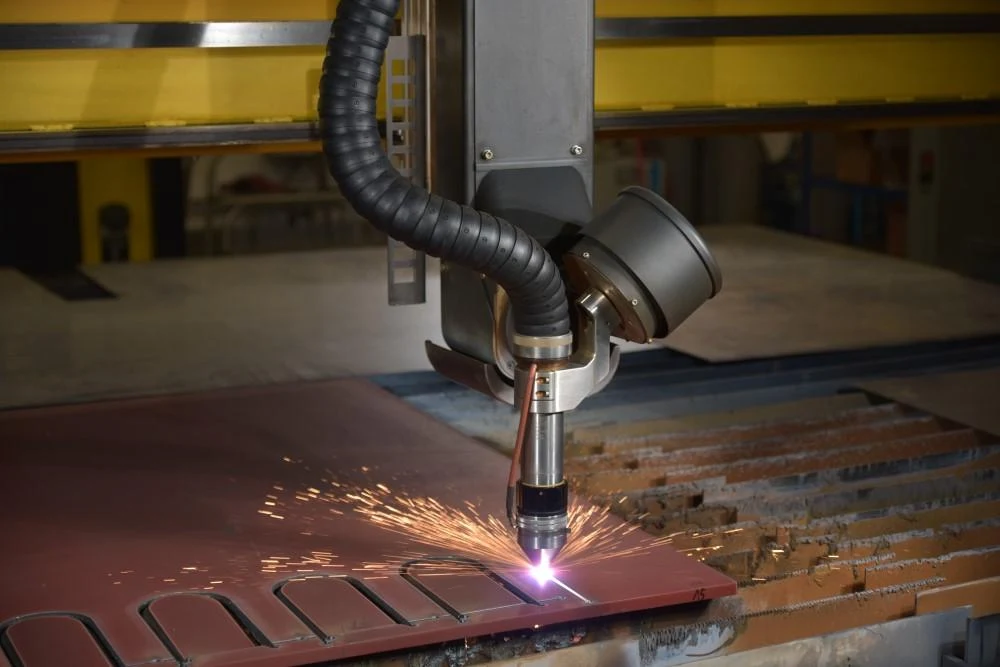 A CNC plasma cutter cutting a medium-thickness aluminum sheet.