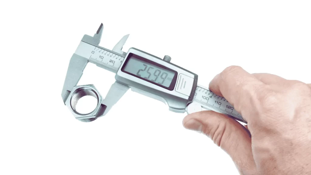 The image shows measuring the thickness of a nut using a vernier caliper.