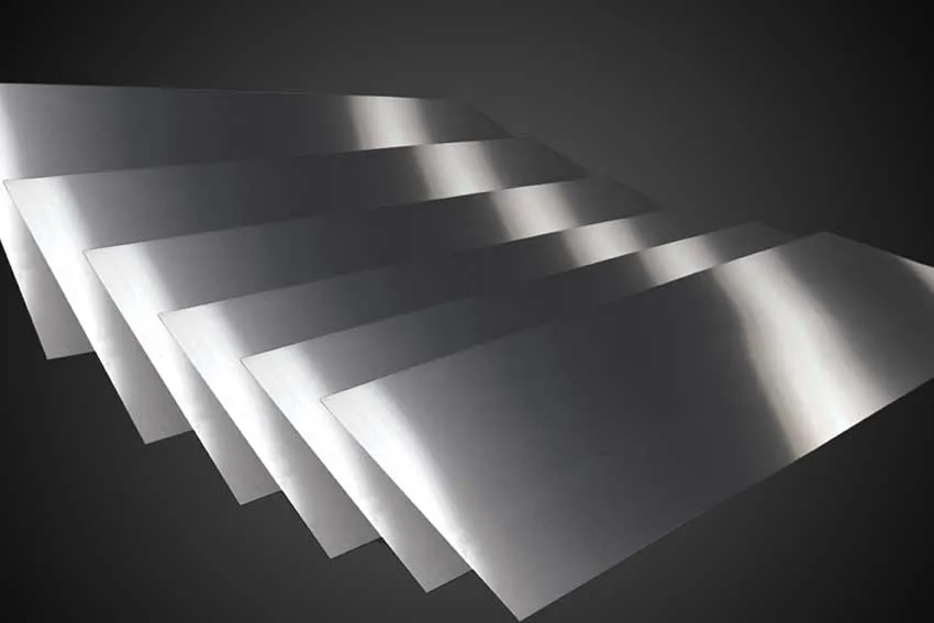 Alt text: Titanium metallic sheets displayed against a dark background