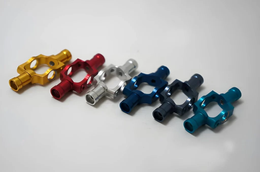 The image shows identical anodized aluminum parts displayed in multiple colors.