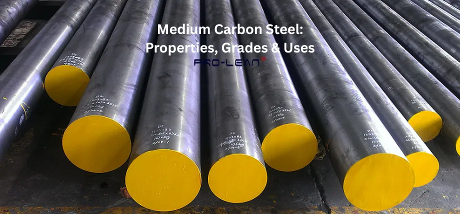 A bundle of large cylindrical medium carbon steel bars with yellow-painted ends, stacked in an industrial setting. Overlaid text reads 