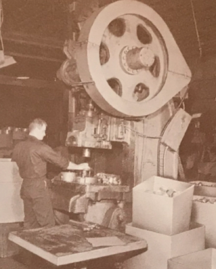 Vintage industrial stamping press machine in operation