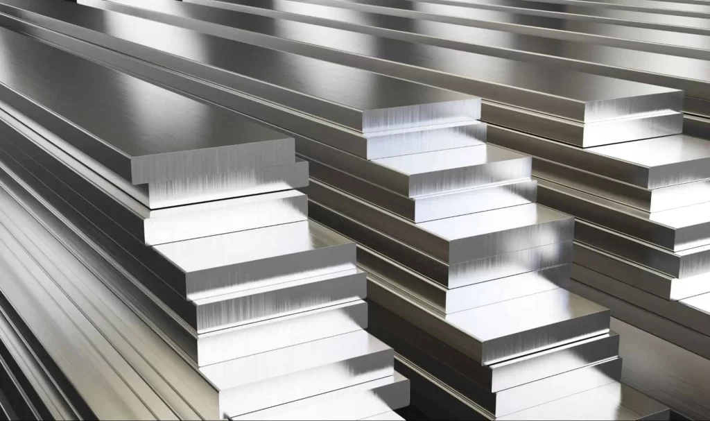 Stacks of raw brushed aluminum alloy flat bars ready for precision machining and specialized anodizing processes.