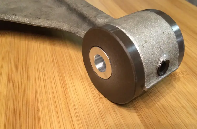 Delrin automotive bushing component showing precision-machined bearing surface for vehicle suspension