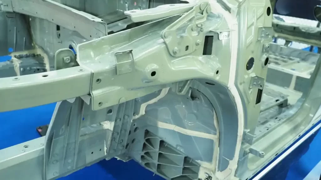 E coated car body frame showing uniform coverage of primer on complex inner panels.