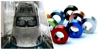 A car body is undergoing e-coating in a factory next to CNC-machined anodized aluminium rings.