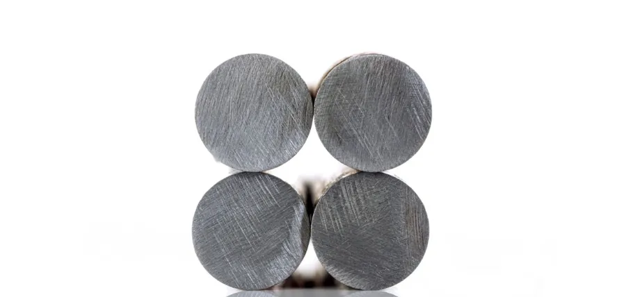 Four cylindrical 4140 alloy steel bars arranged in a square formation, viewed end-on to display their circular cross-sections and fine machined surface finish.