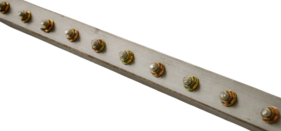 Row of installed Huck bolts (lockbolts) with collar swaging, showing permanent high-strength fastening in rivets vs bolts comparison.